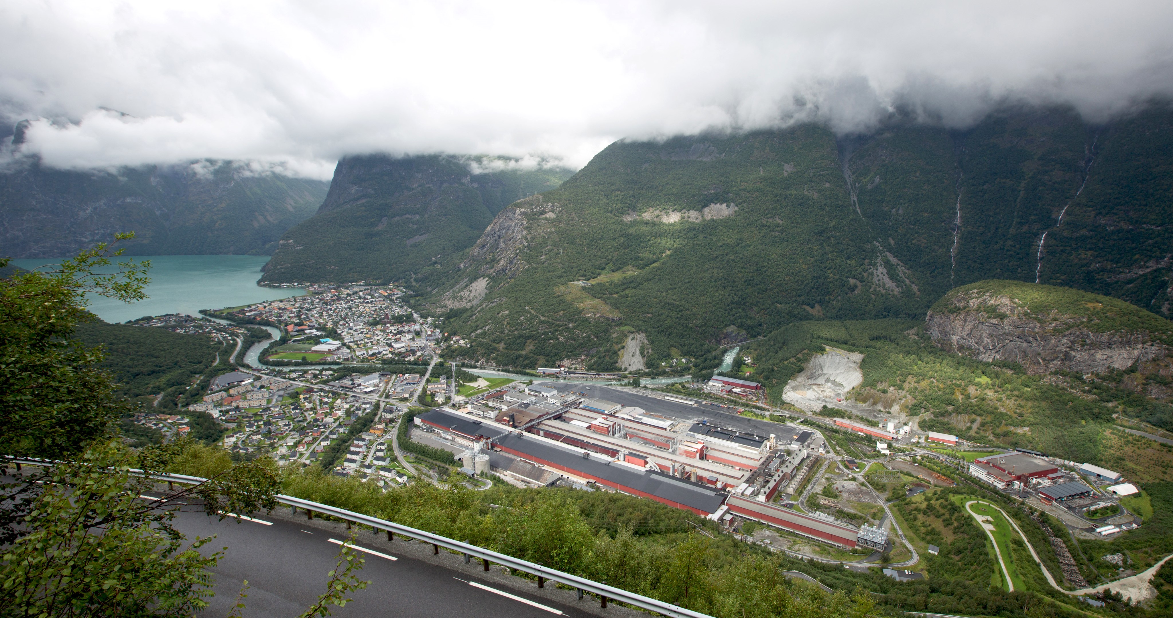 a large building with a road and trees around it