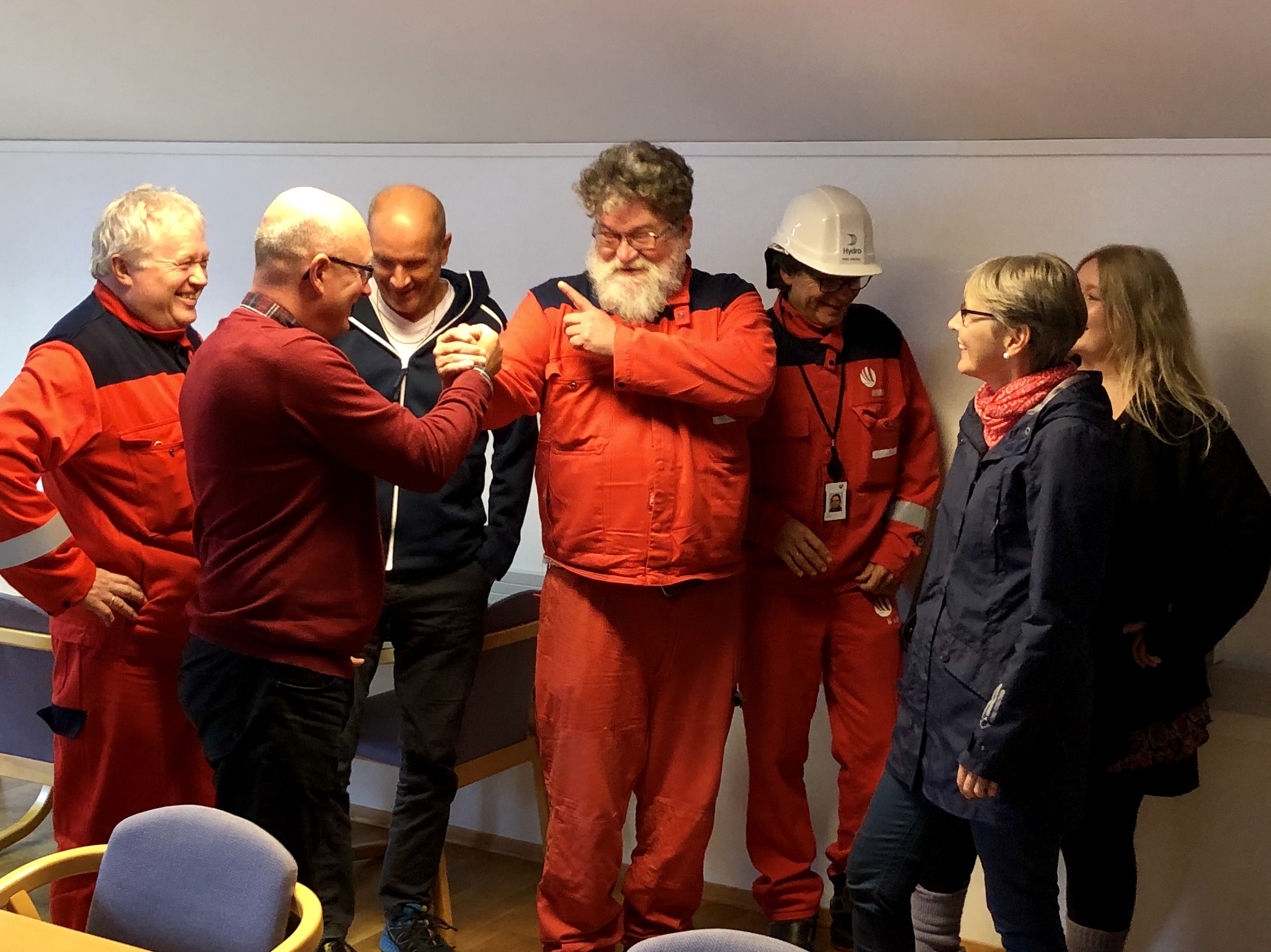 a group of people in red jumpsuits